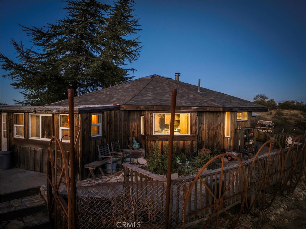 2505 Smith Road Bradley, CA 93426 - Photo 9 of 72 a view of a house with a small yard and table and chairs under an umbrella