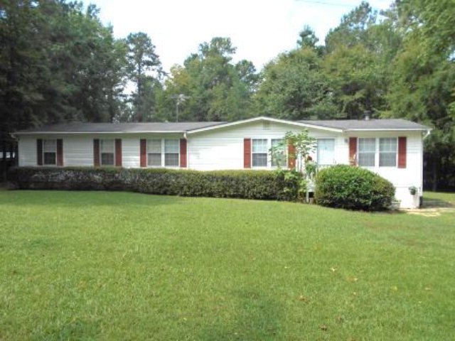 626 Tharpe Road, Unit 5A Musella, GA 31066 - Photo 1 of 9 a view of a house with a yard and potted plants
