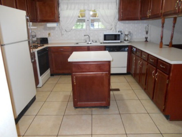 626 Tharpe Road, Unit 5A Musella, GA 31066 - Photo 4 of 9 a kitchen with stainless steel appliances granite countertop a stove a sink and a refrigerator