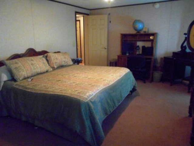 626 Tharpe Road, Unit 5A Musella, GA 31066 - Photo 5 of 9 a bedroom with a bed and dresser