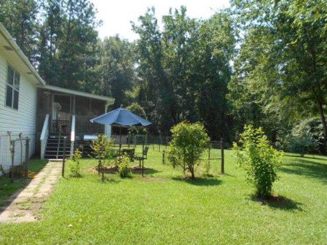 626 Tharpe Road, Unit 5A Musella, GA 31066 - Photo 8 of 9 a view of a chair and table in the garden
