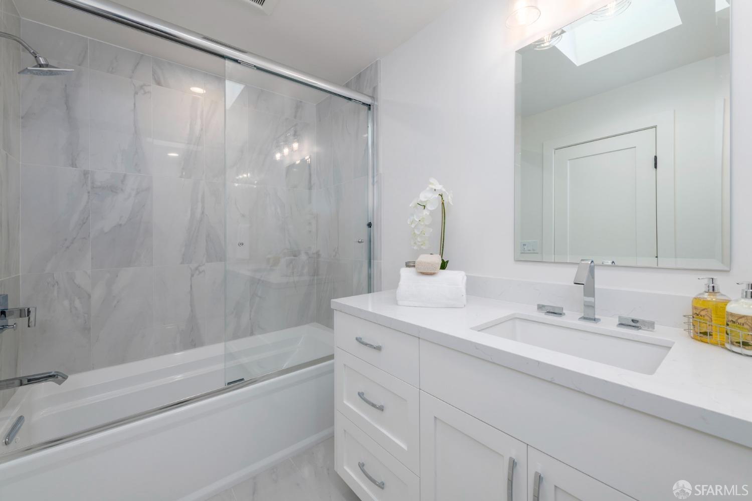 155 Brookwood Road Woodside, CA 94062 - Photo 25 of 60 a bathroom with a bathtub shower sink vanity and mirror