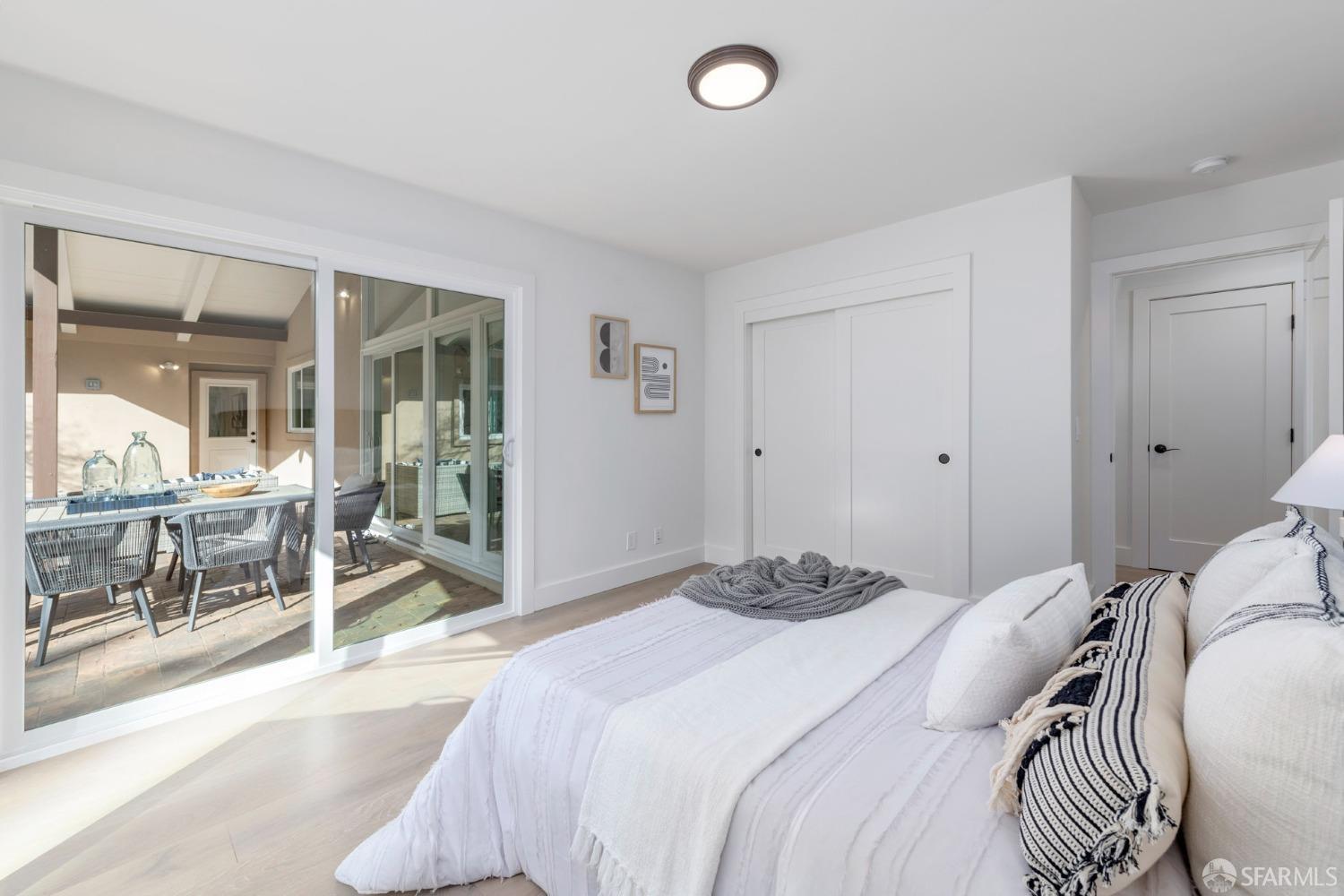 155 Brookwood Road Woodside, CA 94062 - Photo 27 of 60 a bedroom with a bed and glass door