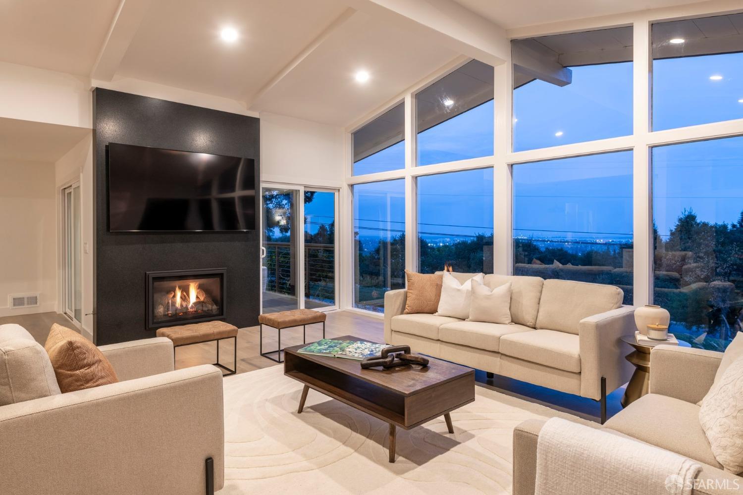 155 Brookwood Road Woodside, CA 94062 - Photo 47 of 60 a living room with furniture ceiling fan and a large window