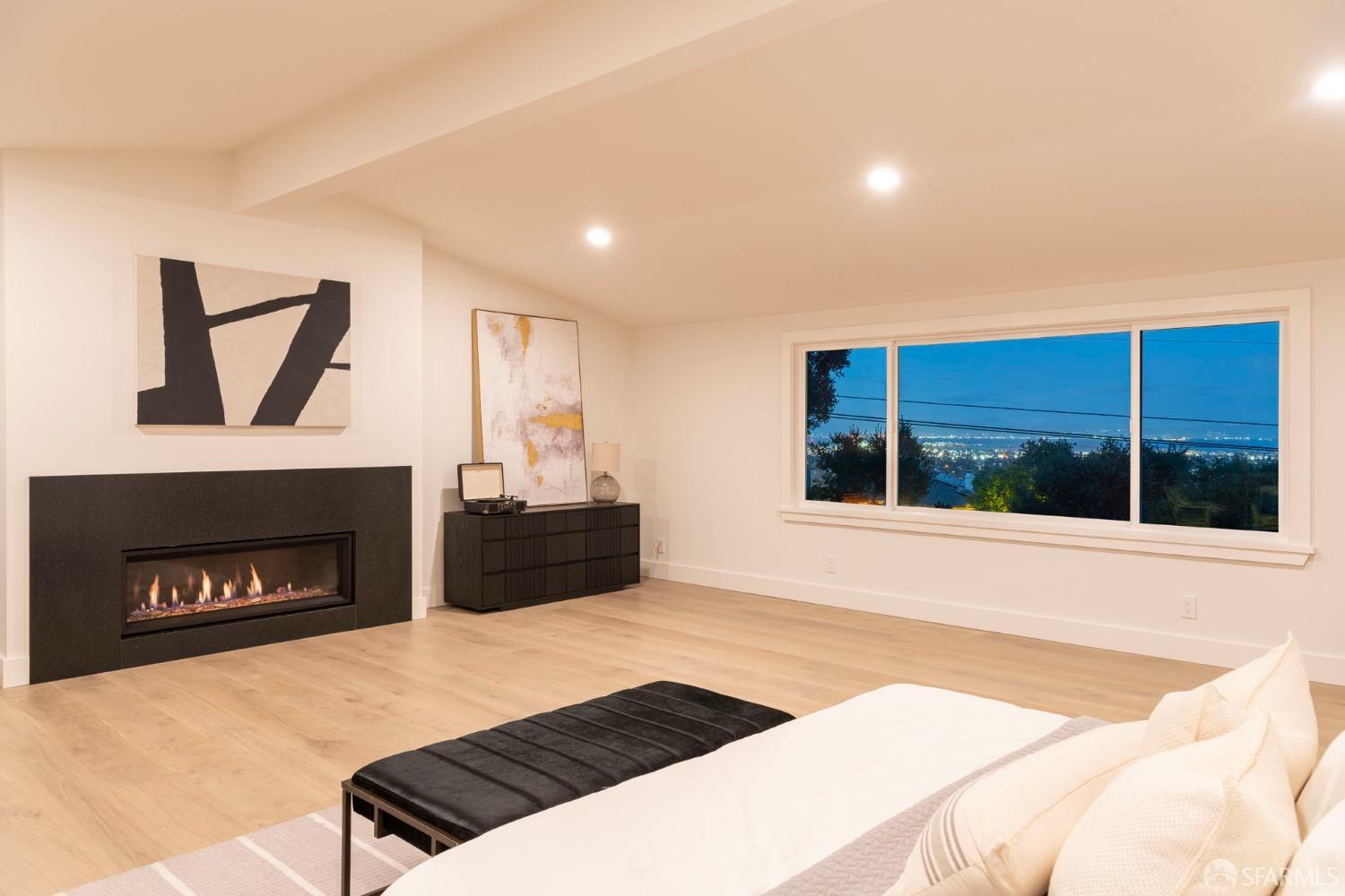 155 Brookwood Road Woodside, CA 94062 - Photo 49 of 60 a bedroom with a bed a fireplace and a large window