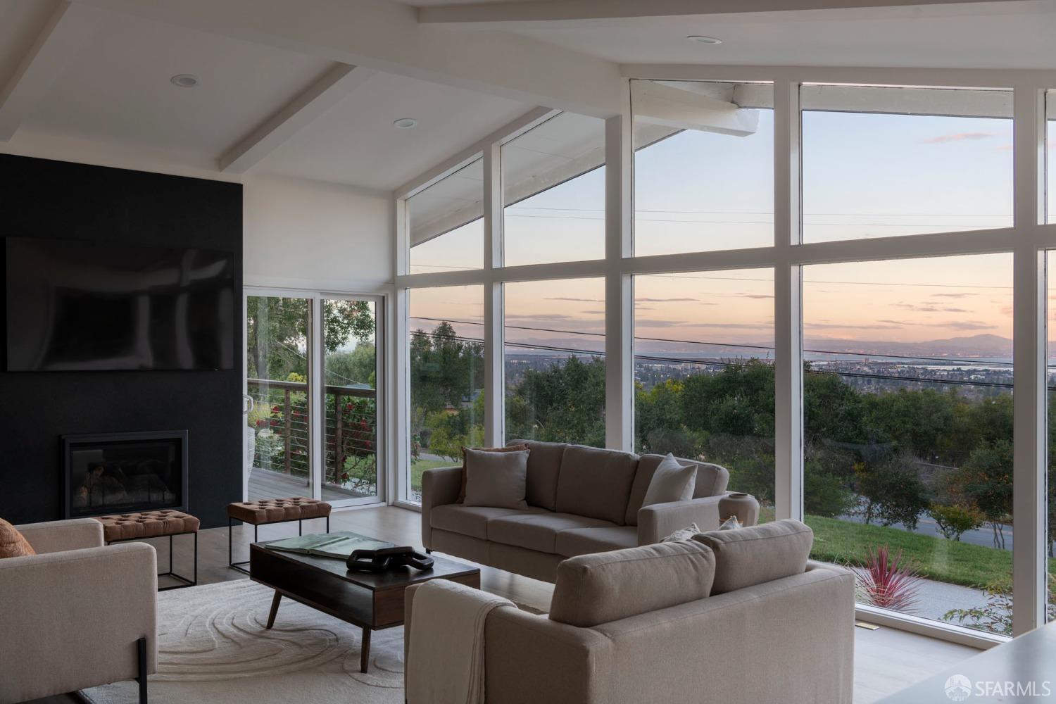 155 Brookwood Road Woodside, CA 94062 - Photo 51 of 60 a living room with furniture tv and a floor to ceiling window