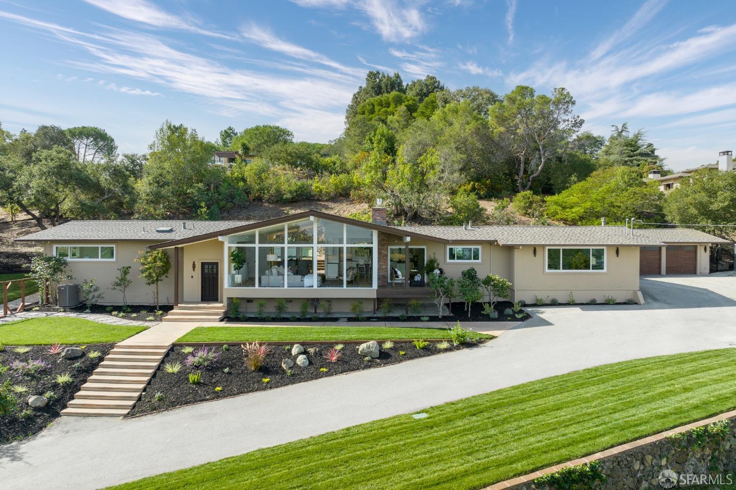 155 Brookwood Road Woodside, CA 94062 - Photo 9 of 60 a front view of a house with a yard