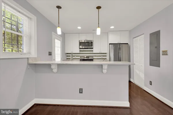a kitchen with stainless steel appliances a refrigerator stove and sink
