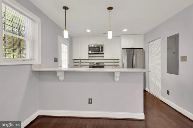 a kitchen with stainless steel appliances a refrigerator stove and sink
