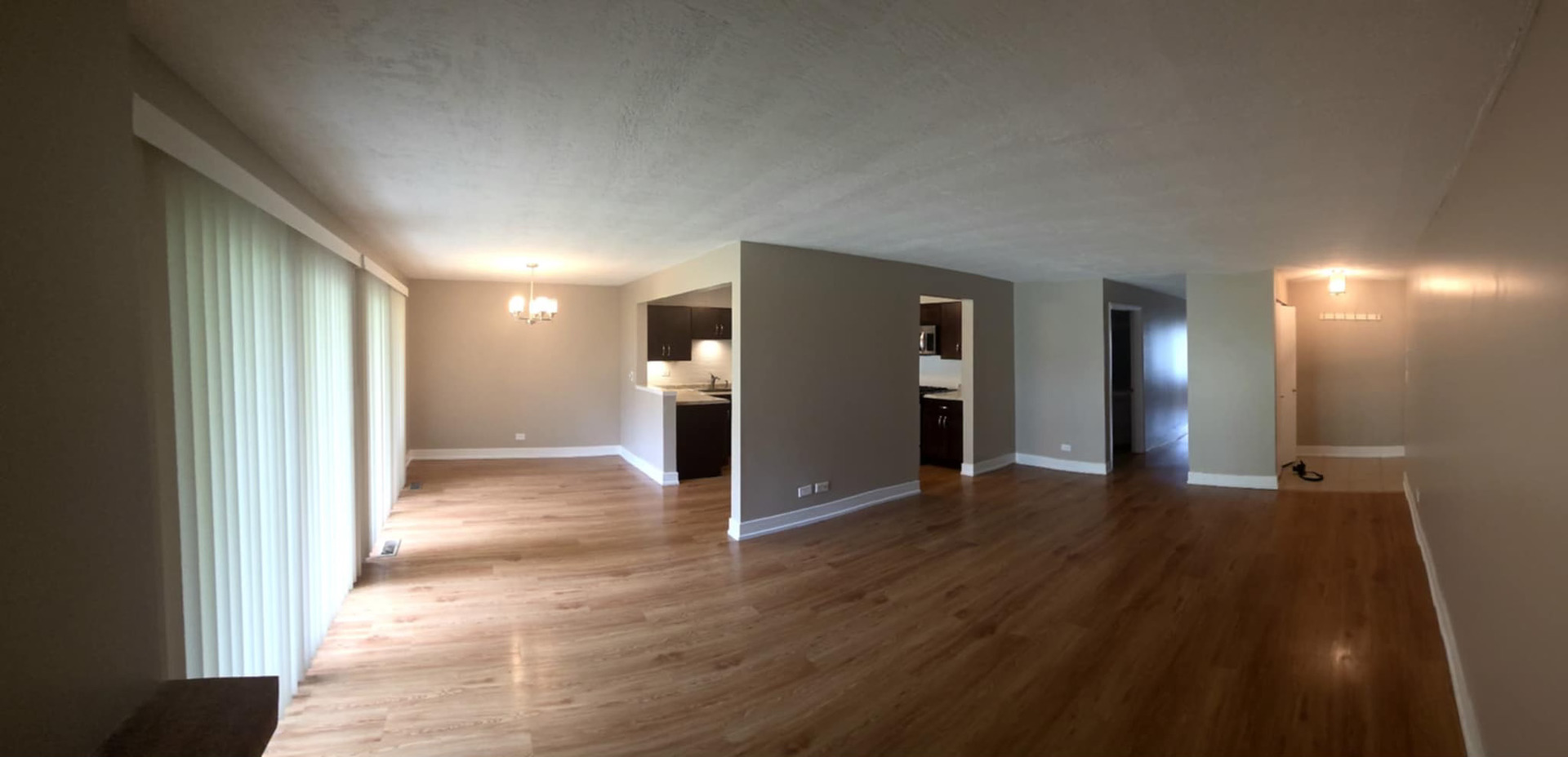 366 Pinetree Lane, Unit B1 Schaumburg, IL 60193 - Photo 6 of 23 a view of a hallway with wooden floor and a bathroom
