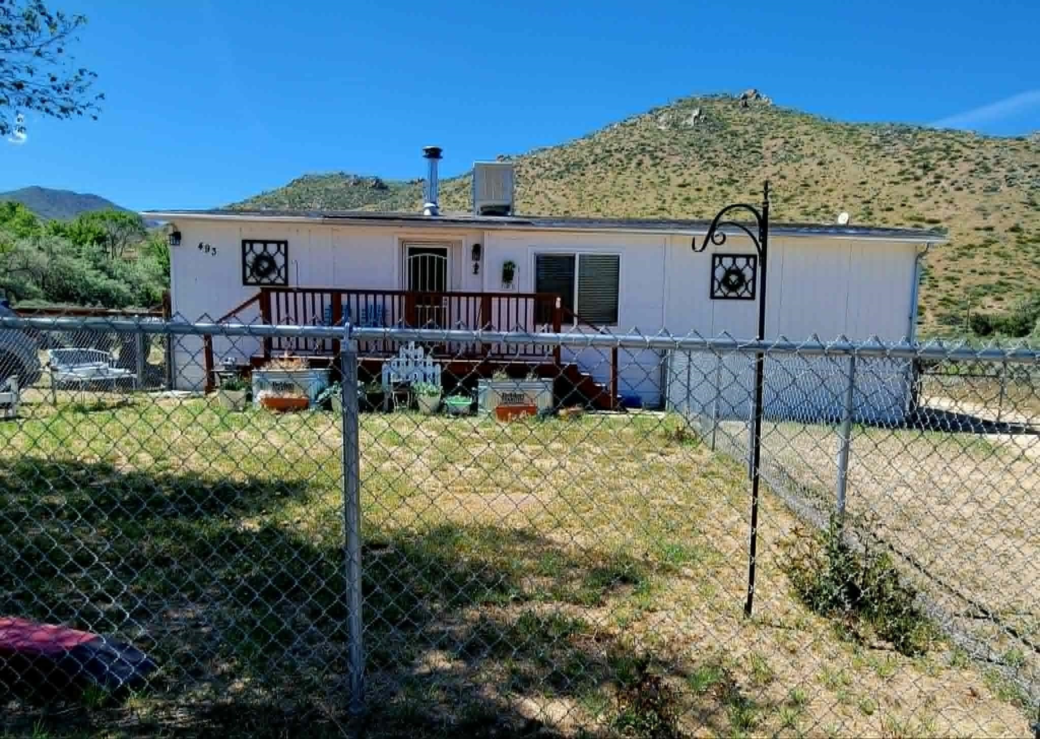 a backyard of a house with table and chairs