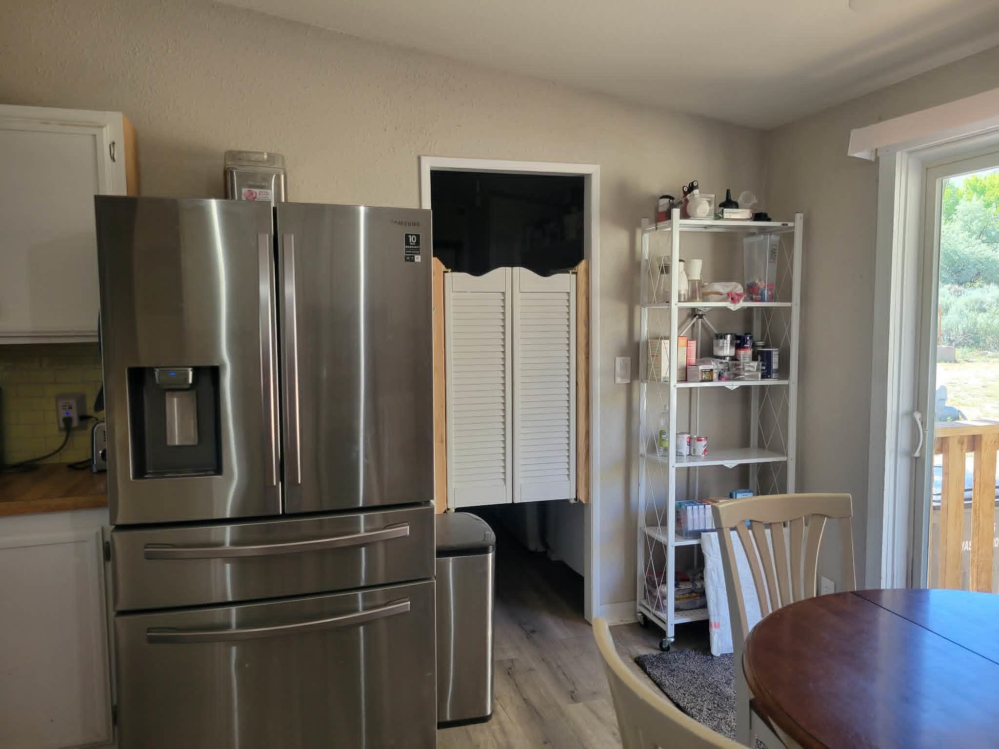 493 Mule Deer Road Coleville, CA 96107 - Photo 13 of 39 a kitchen with stainless steel appliances a refrigerator and a chair
