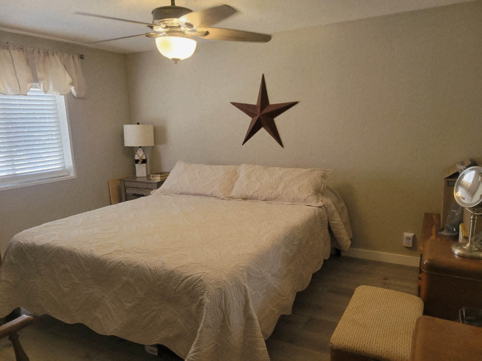 493 Mule Deer Road Coleville, CA 96107 - Photo 21 of 39 a bedroom with a bed and a chandelier