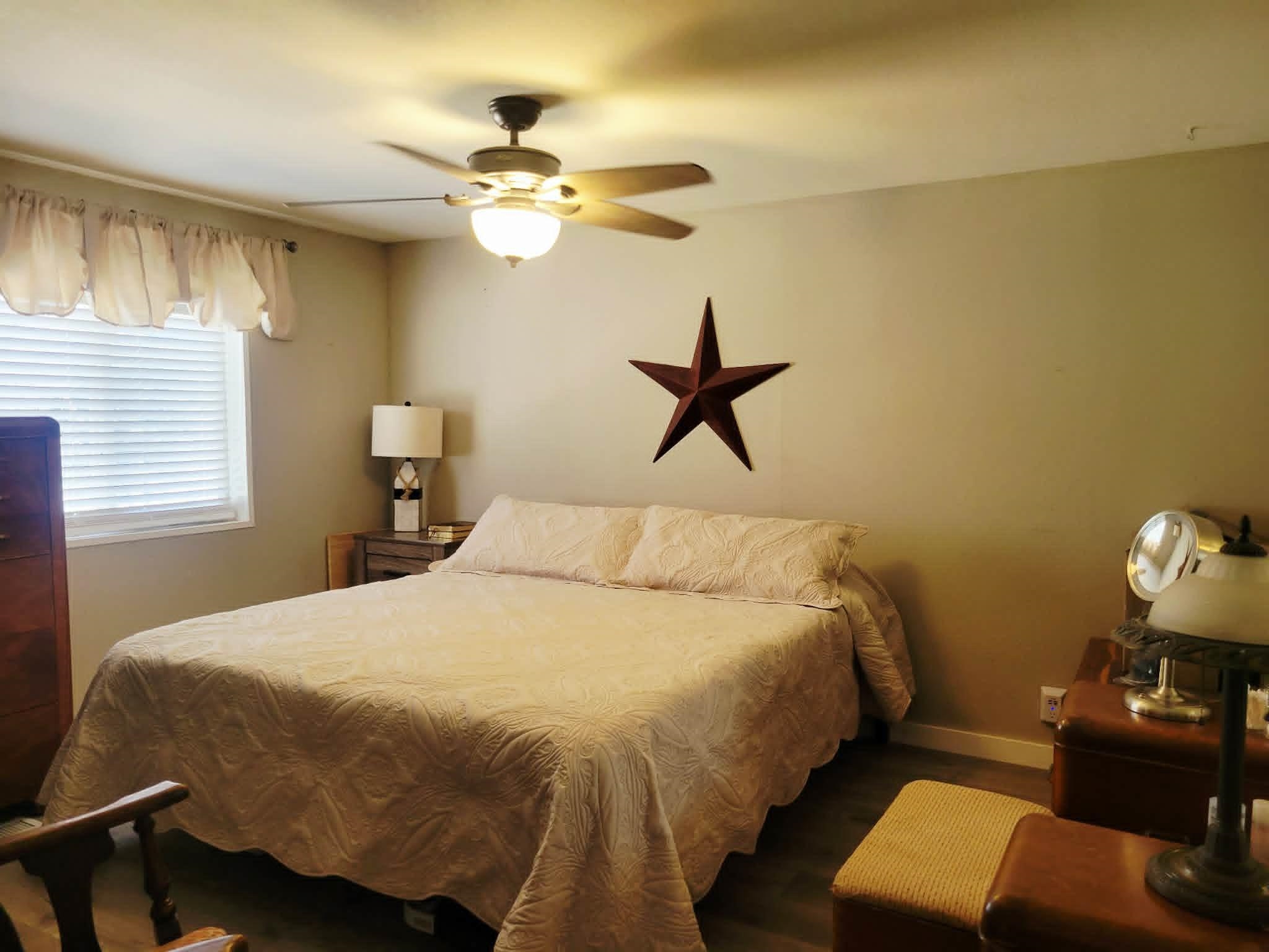493 Mule Deer Road Coleville, CA 96107 - Photo 22 of 39 a bedroom with a bed and wooden floor