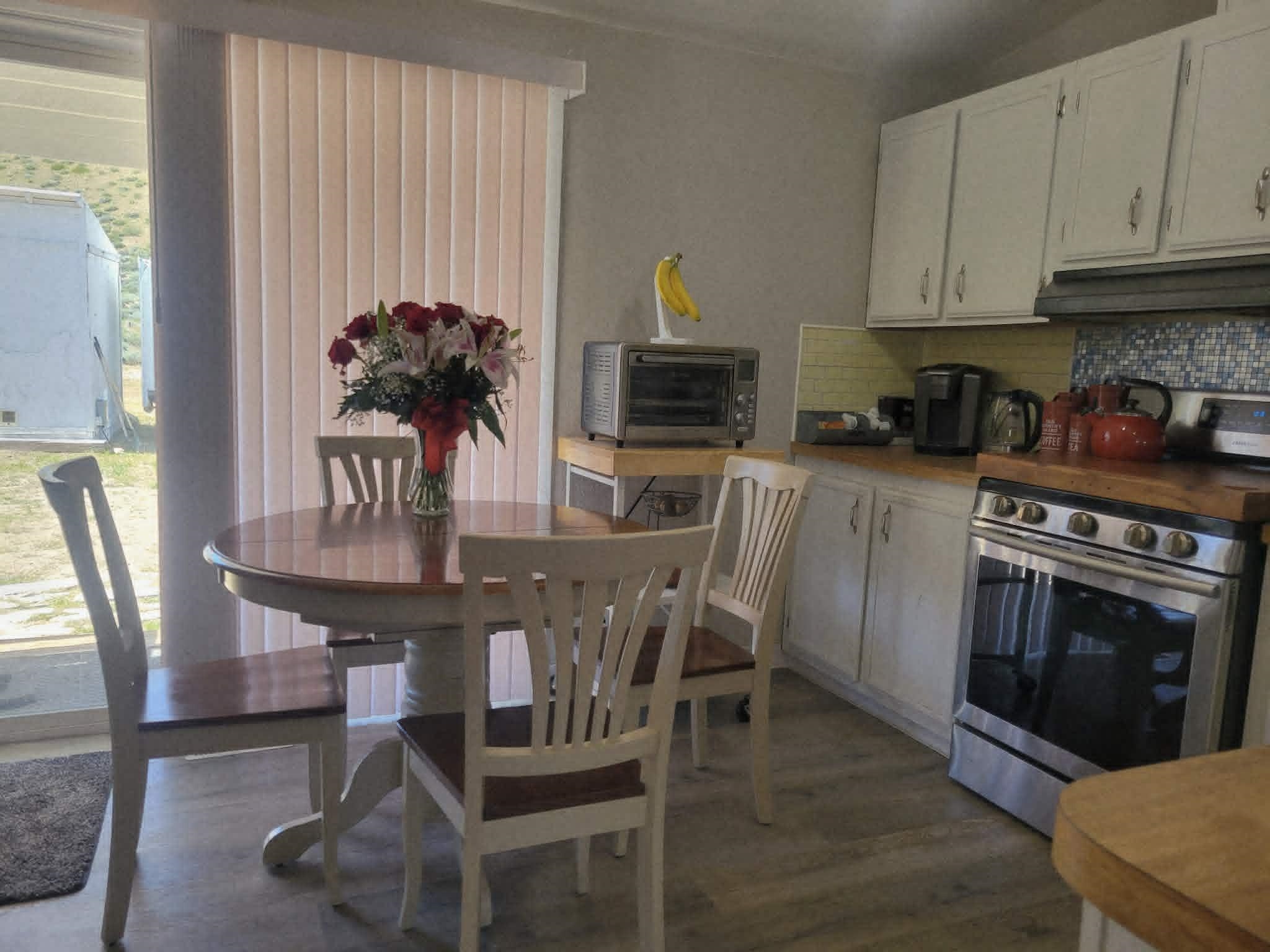 493 Mule Deer Road Coleville, CA 96107 - Photo 7 of 39 a kitchen with stainless steel appliances a dining table chairs and a refrigerator