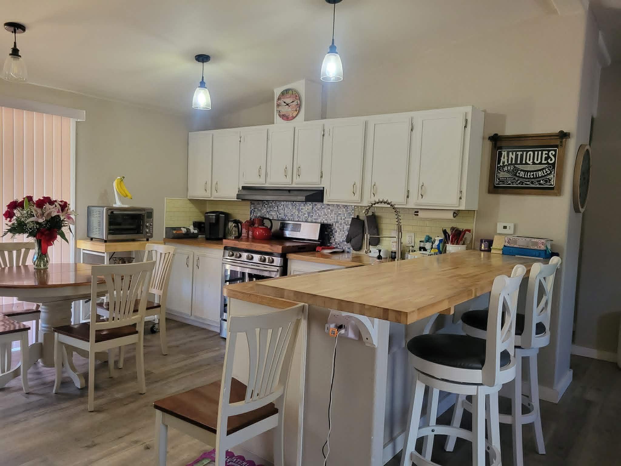 493 Mule Deer Road Coleville, CA 96107 - Photo 8 of 39 a kitchen with stainless steel appliances granite countertop a table chairs sink and cabinets