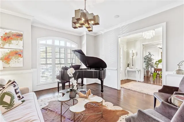 a living room with furniture wooden floor and a large window