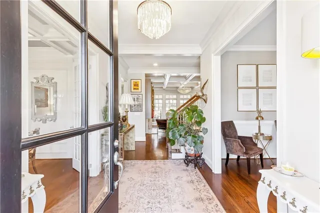 a living room with furniture kitchen view and large windows