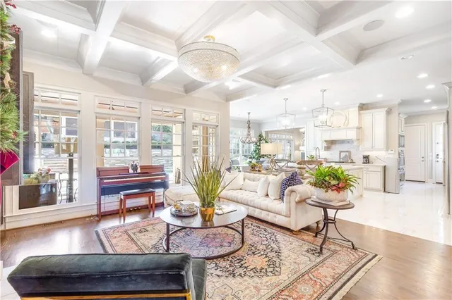 a living room with furniture and floor to ceiling windows