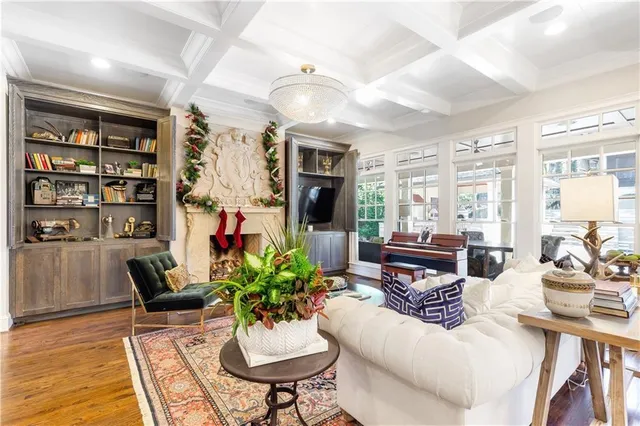 a kitchen with a sink a stove and chairs with white cabinets