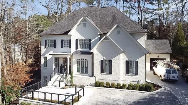 a front view of a house with yard porch and outdoor seating