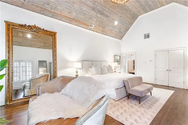 a bedroom with a bed couch and window