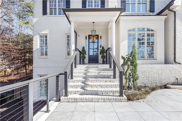 a front view of a residential houses with yard