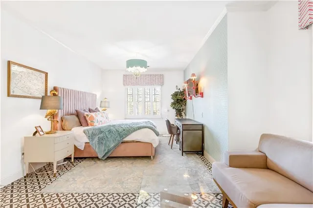 a dining room with furniture and a large window