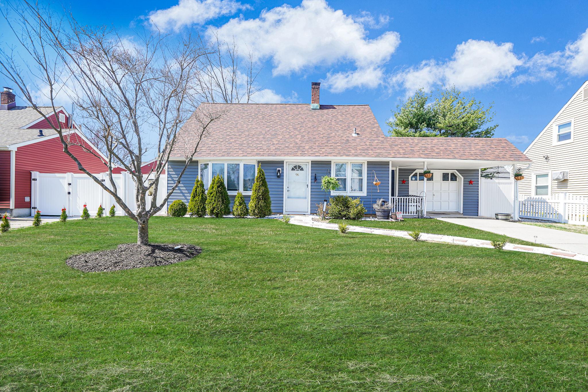 96 Ranch Lane Levittown, NY 11756 - Photo 1 of 1 View of front of home featuring a chimney, fence, a front lawn, a gate, and driveway
