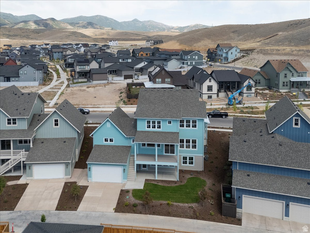 7189 South Sage Road, Unit 214 West Jordan, UT 84081 - Photo 7 of 29 Two-story residential property featuring a light blue exterior, a covered second-story balcony, and a walk-out patio