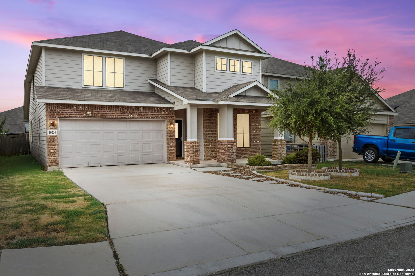 a front view of a house with a yard and garage