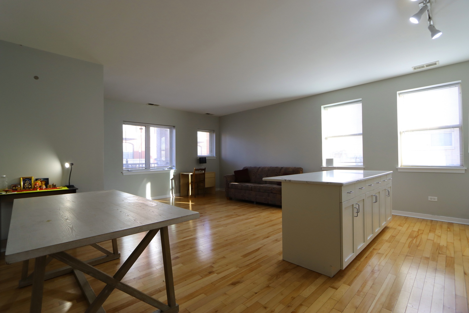 914 South Racine Avenue, Unit 101 Chicago, IL 60607 - Photo 3 of 17 a living room with dining room and wooden floor