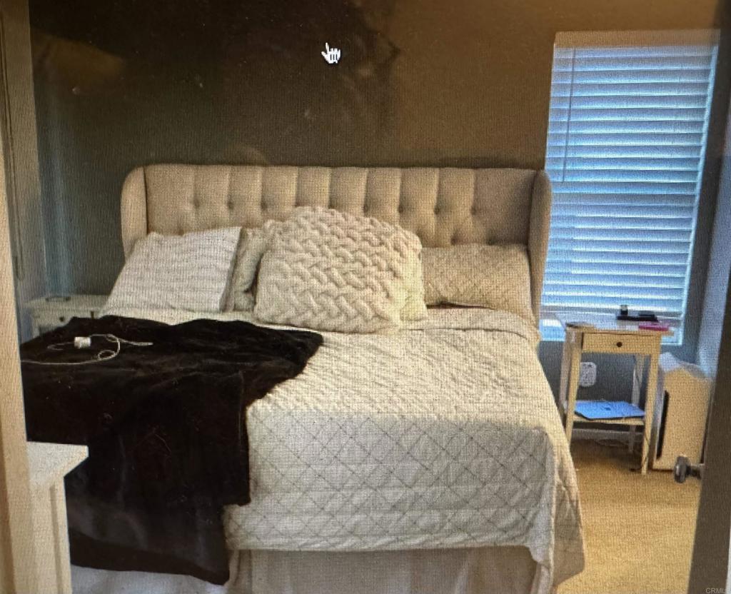 16941 Meadowlark Ridge Road, Unit 1 San Diego, CA 92127 - Photo 13 of 30 a bed sitting in a bedroom next to a window