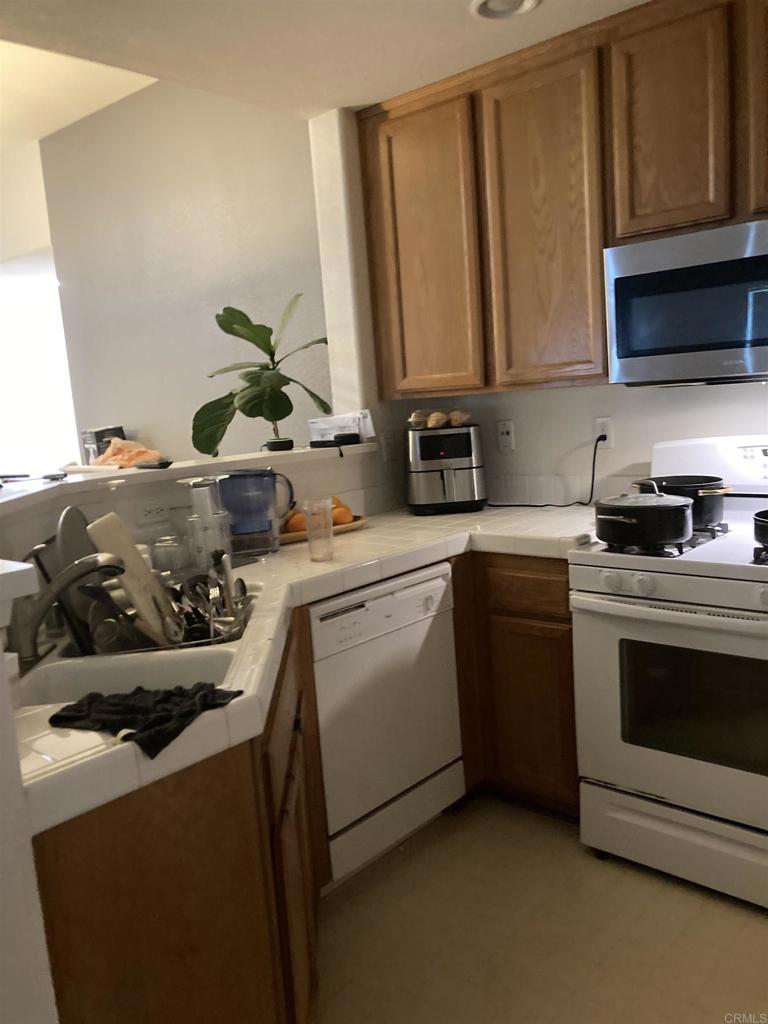 16941 Meadowlark Ridge Road, Unit 1 San Diego, CA 92127 - Photo 20 of 30 a kitchen with a sink a stove and cabinets