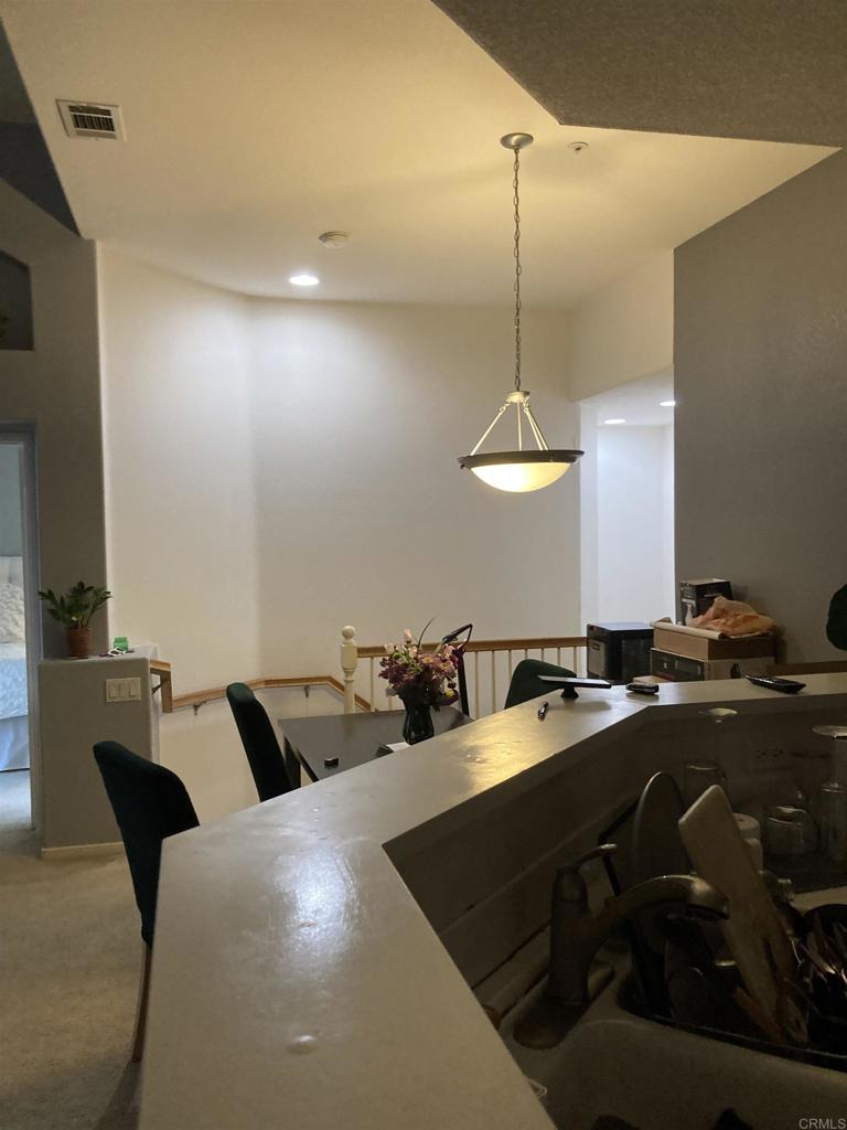 16941 Meadowlark Ridge Road, Unit 1 San Diego, CA 92127 - Photo 21 of 30 a kitchen with a table chairs and a couch