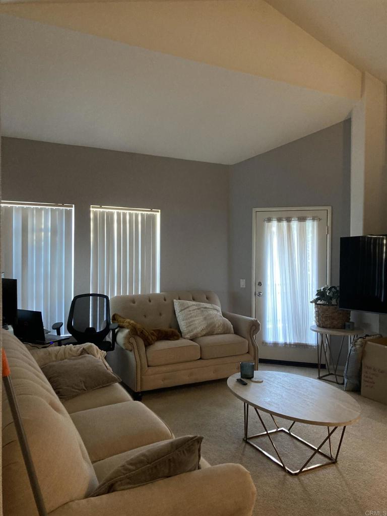 16941 Meadowlark Ridge Road, Unit 1 San Diego, CA 92127 - Photo 9 of 30 a living room with furniture and a flat screen tv