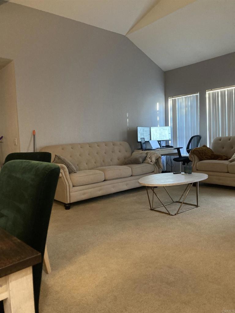 16941 Meadowlark Ridge Road, Unit 1 San Diego, CA 92127 - Photo 10 of 30 a living room with furniture and a lamp