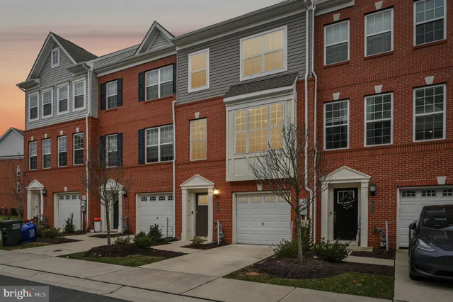 a front view of a residential apartment building with a yard