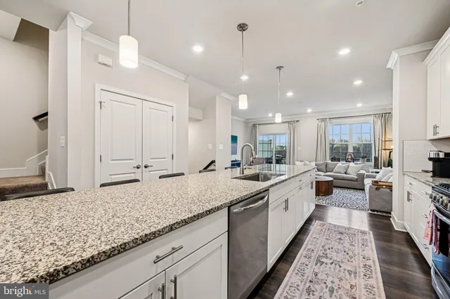 a large white kitchen with lots of counter space sink and appliances