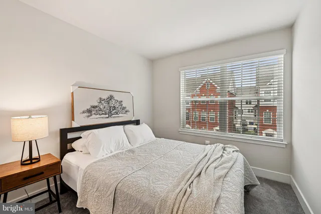 a bedroom with a large bed and a lamp