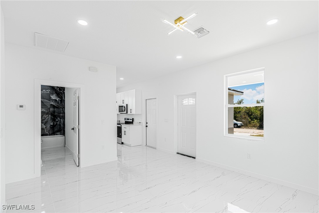 3604 26th Street Southwest Lehigh Acres, FL 33976 - Photo 15 of 38 a view of a hallway with wooden shelves