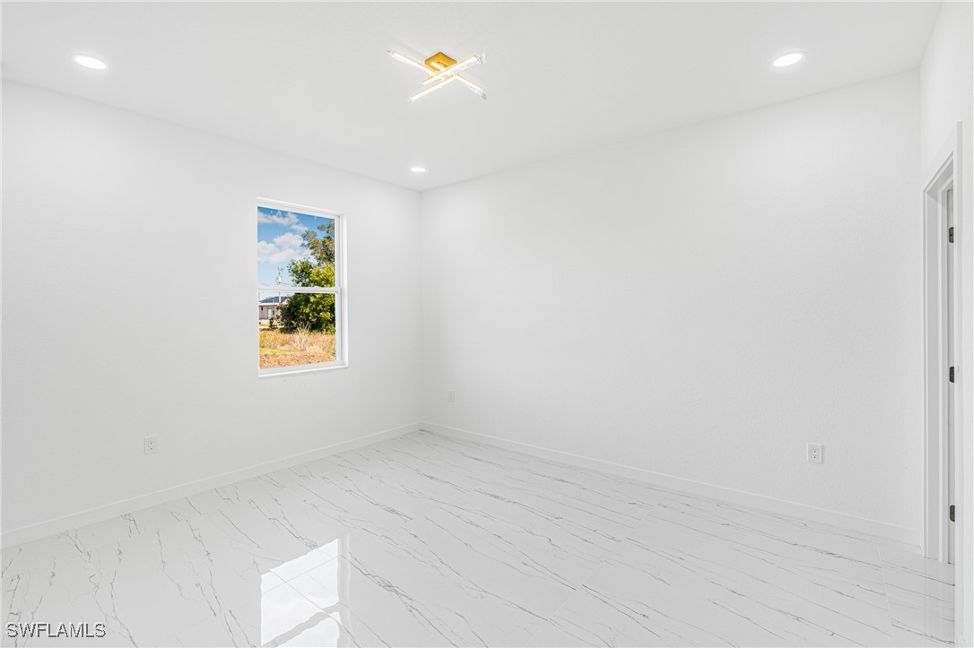 3604 26th Street Southwest Lehigh Acres, FL 33976 - Photo 18 of 38 an empty room with windows and entrance