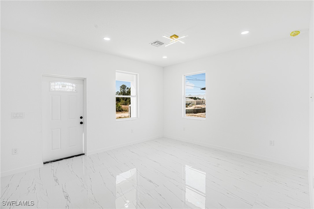 3604 26th Street Southwest Lehigh Acres, FL 33976 - Photo 20 of 38 an empty room with windows
