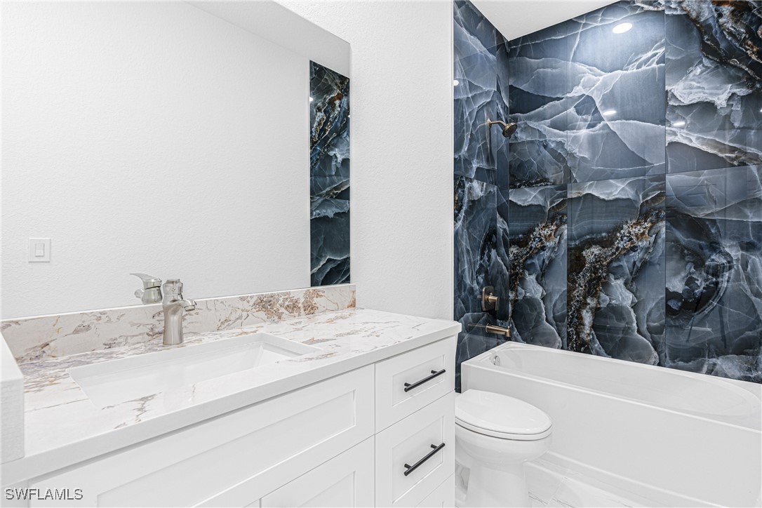 3604 26th Street Southwest Lehigh Acres, FL 33976 - Photo 27 of 38 a bathroom with a sink a toilet and shower