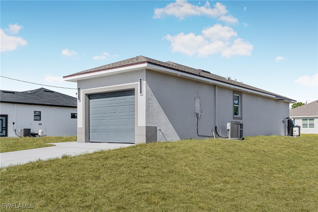 3604 26th Street Southwest Lehigh Acres, FL 33976 - Photo 3 of 38 a front view of a house with garage