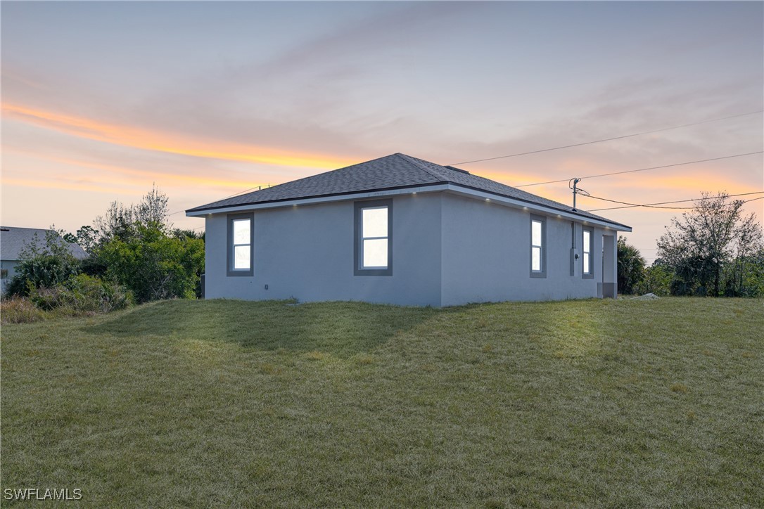 3604 26th Street Southwest Lehigh Acres, FL 33976 - Photo 31 of 38 a house view with backyard space