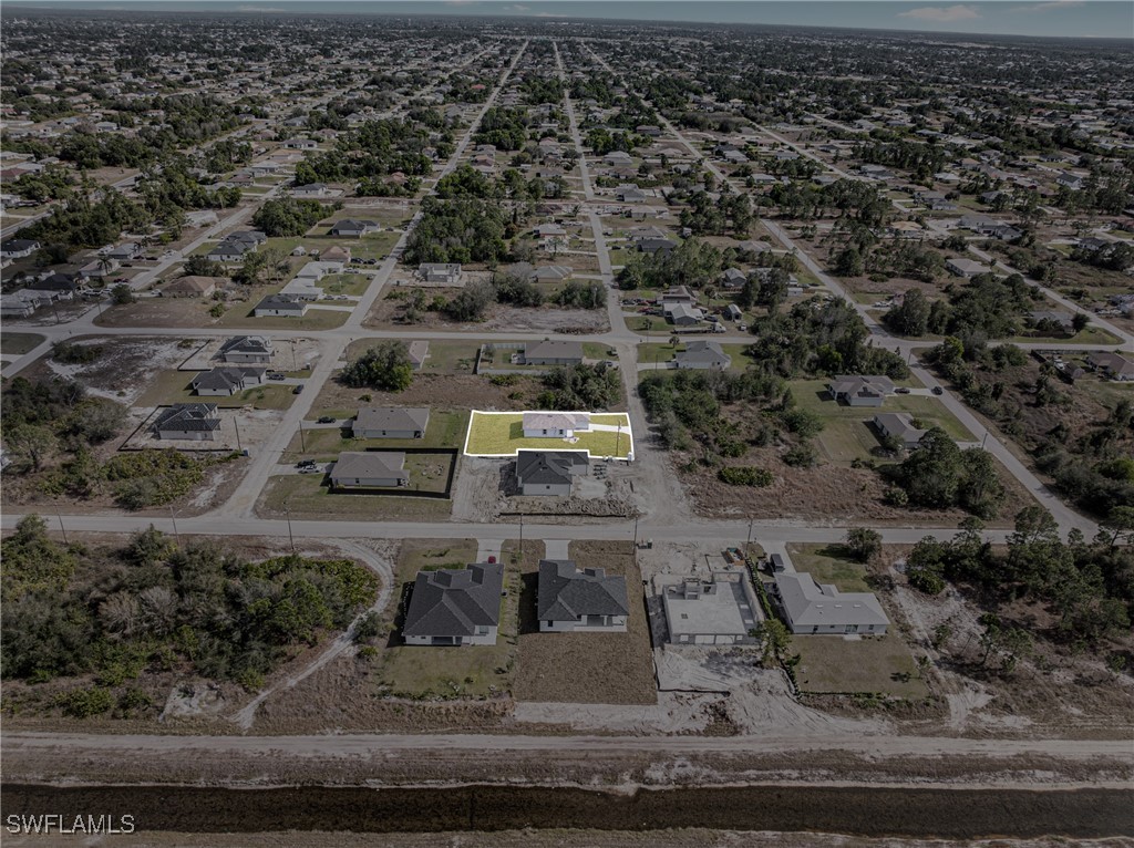 3604 26th Street Southwest Lehigh Acres, FL 33976 - Photo 33 of 38 an aerial view of a houses with yard