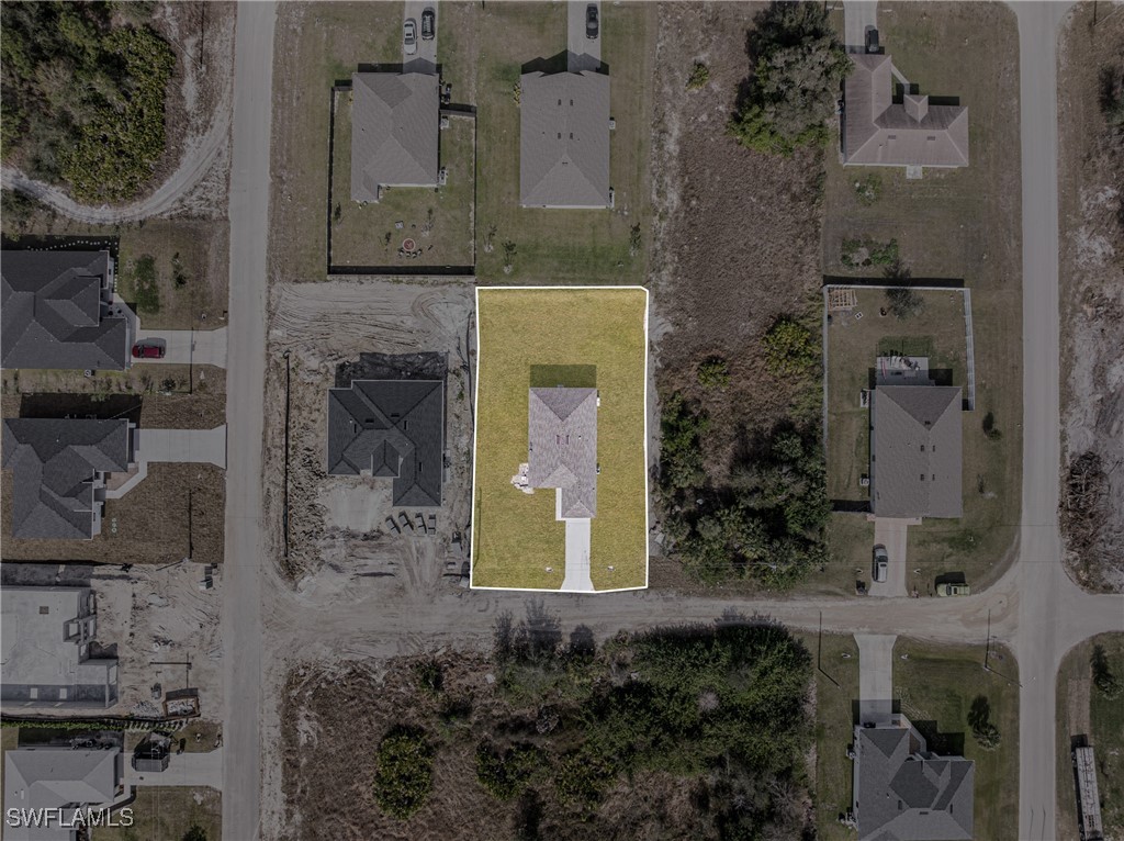 3604 26th Street Southwest Lehigh Acres, FL 33976 - Photo 34 of 38 a front view of a house with a yard