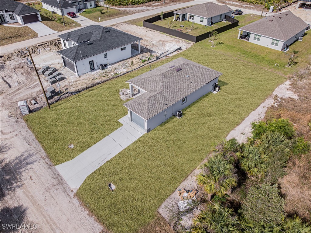 3604 26th Street Southwest Lehigh Acres, FL 33976 - Photo 37 of 38 a view of a house with a yard
