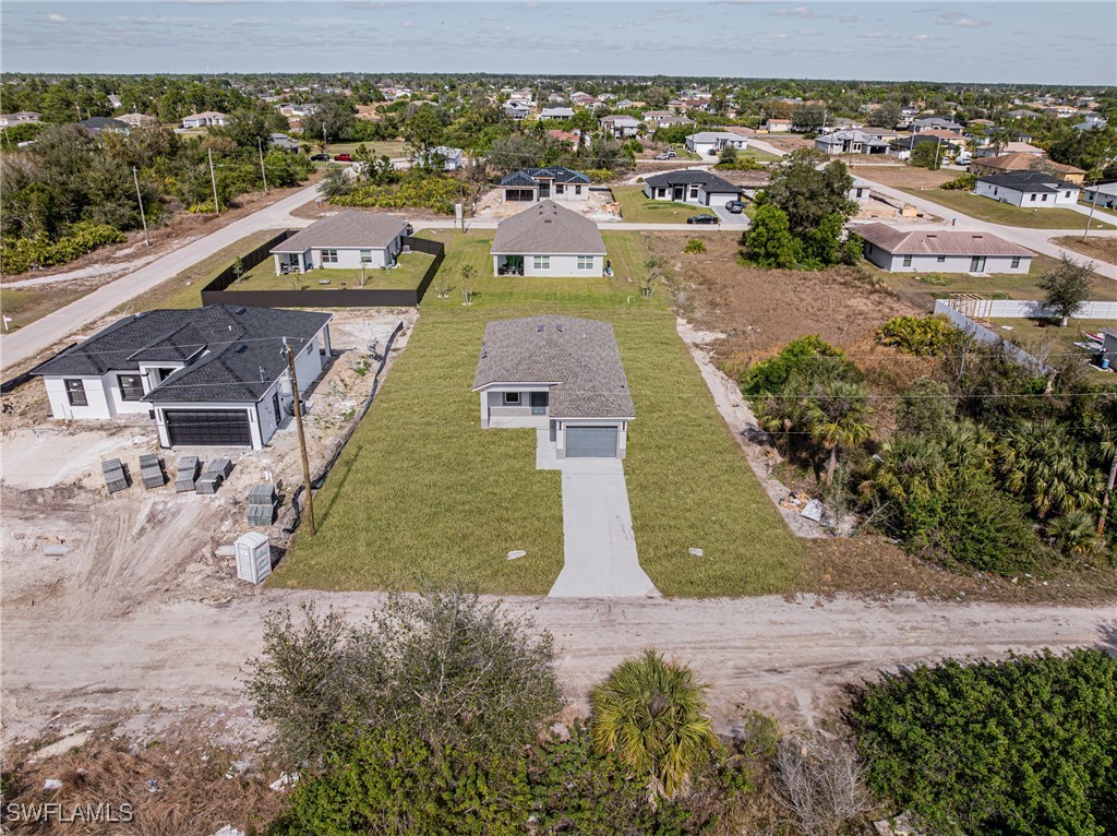3604 26th Street Southwest Lehigh Acres, FL 33976 - Photo 38 of 38 an aerial view of residential houses with outdoor space